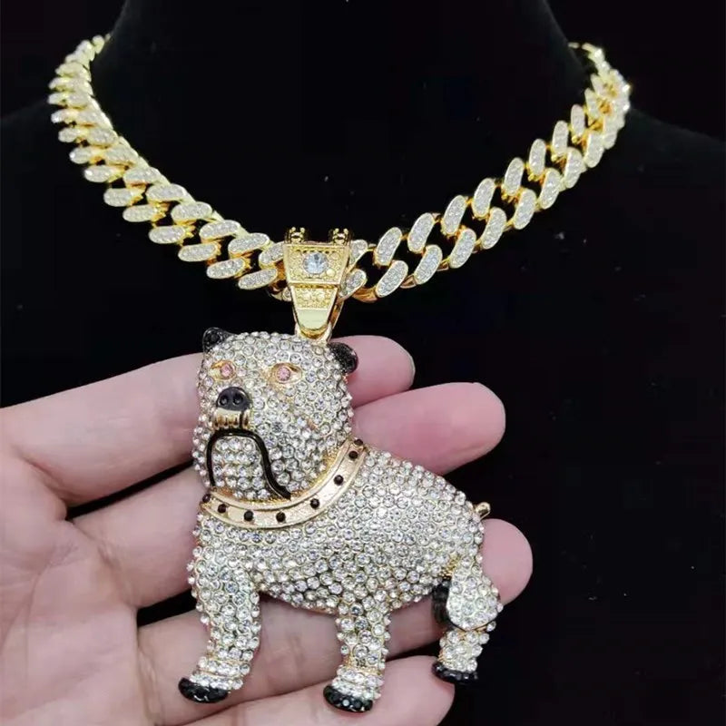 Gold dog pendant necklace held in a hand