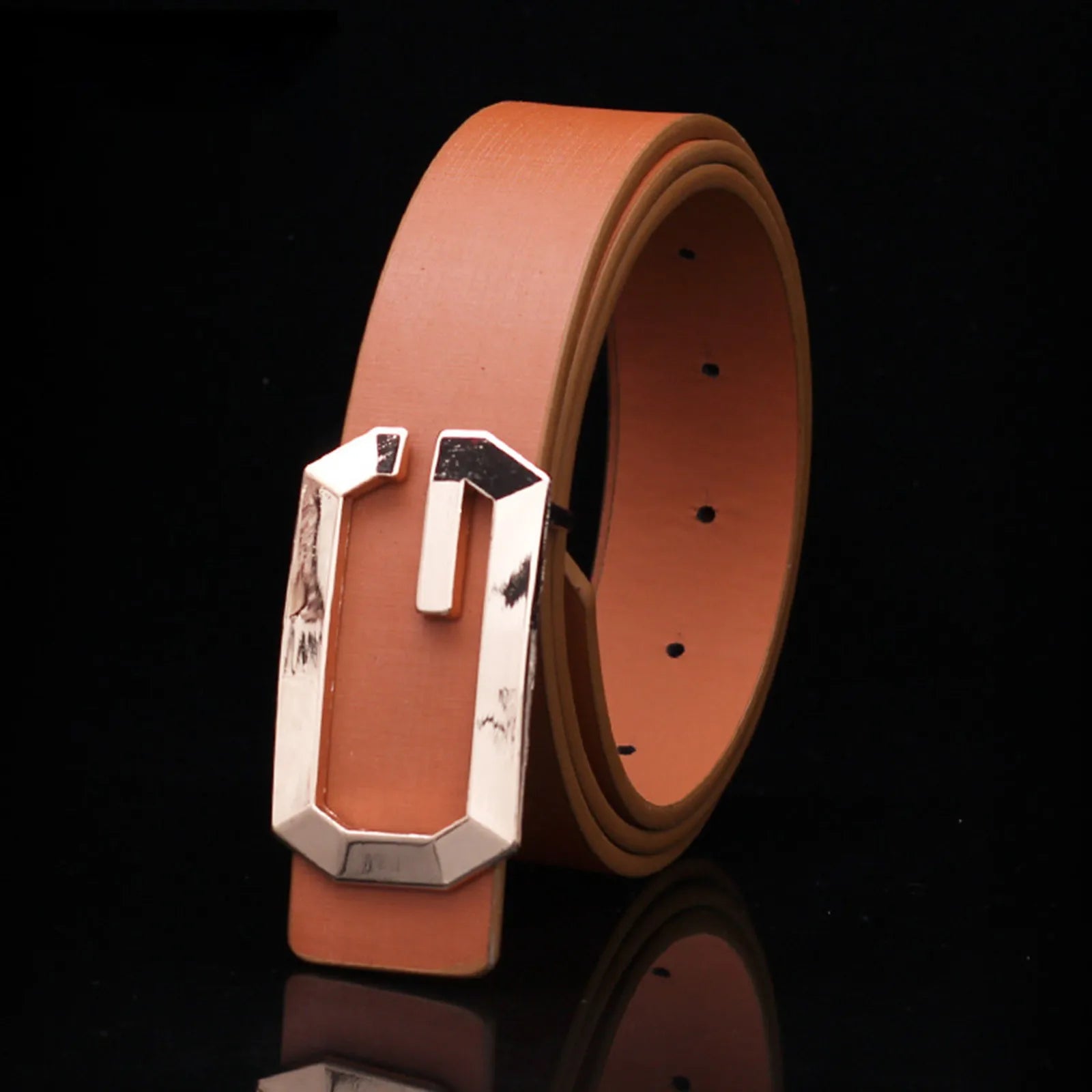 Brown leather belt with a silver buckle on a black background