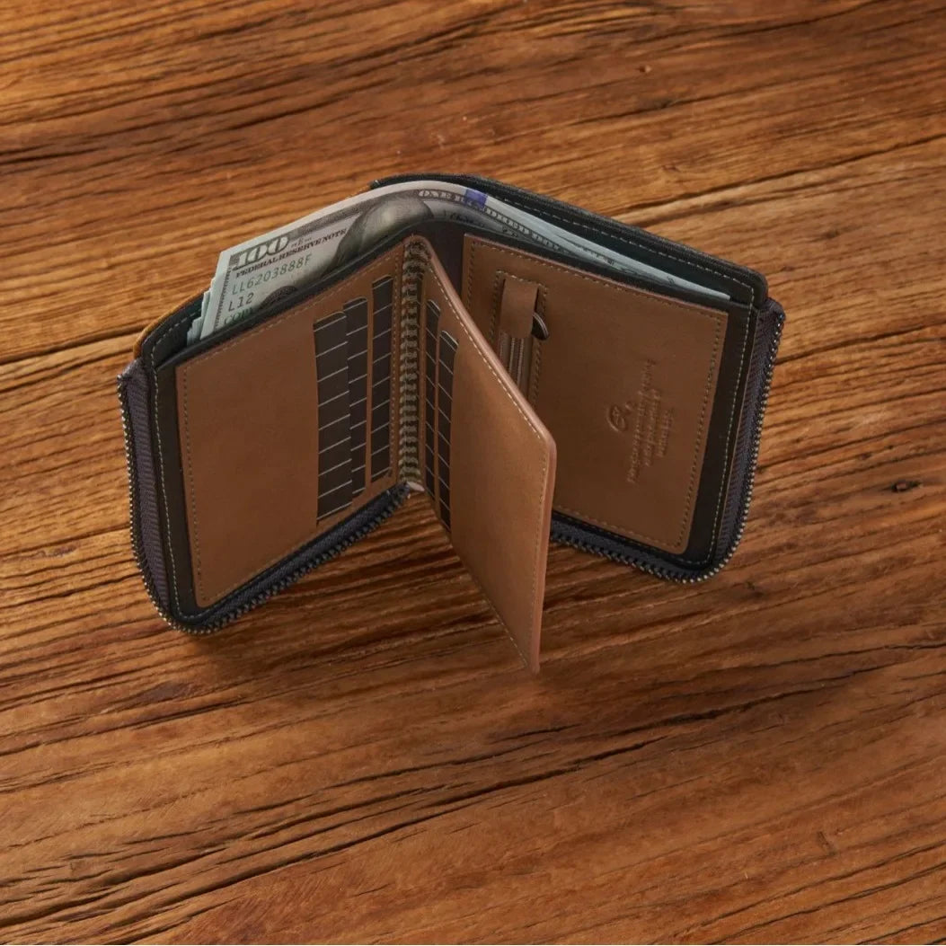 Brown leather wallet with black trim on a wooden surface