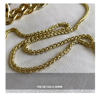 Gold chain on a textured white surface