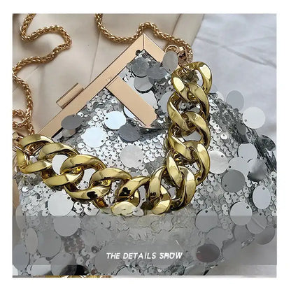 Gold chain necklace on a sequined surface with 'The Details Show' text.