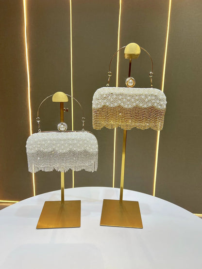 Two beaded Carauana Pearl Clutch Purse golden and silver on stand