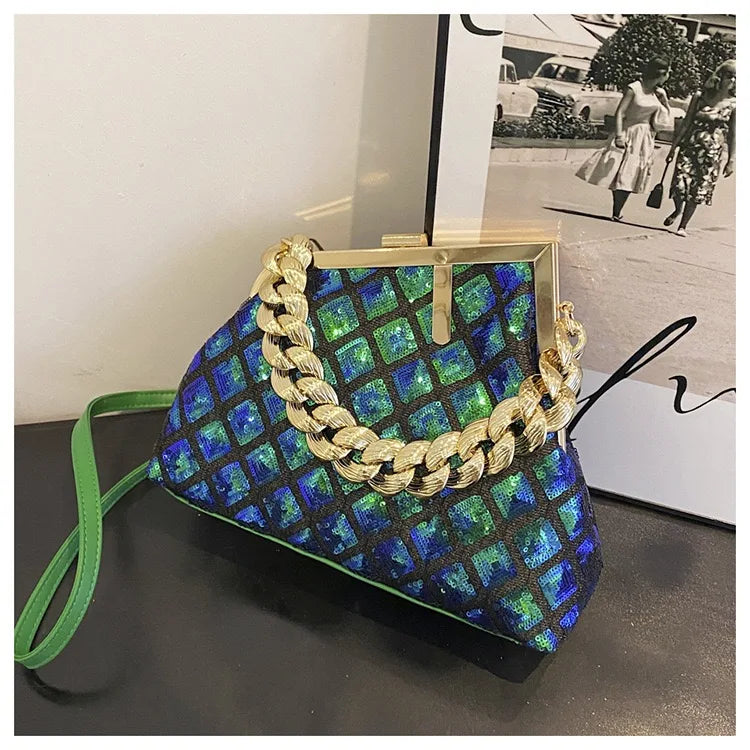 Patterned handbag with gold chain detail on a dark surface