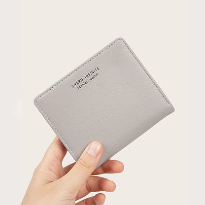 Gray wallet held by a hand