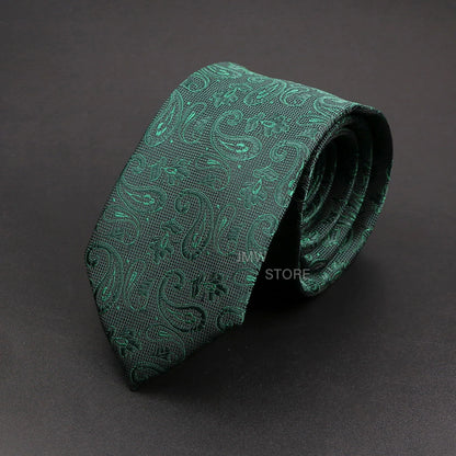 Green paisley patterned tie on a dark gray background