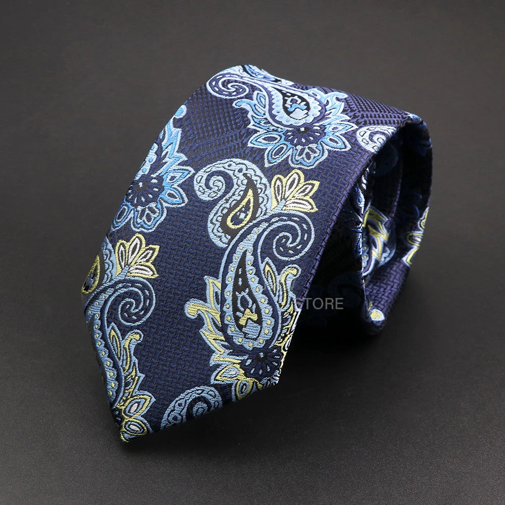 Navy blue paisley patterned tie on a dark background