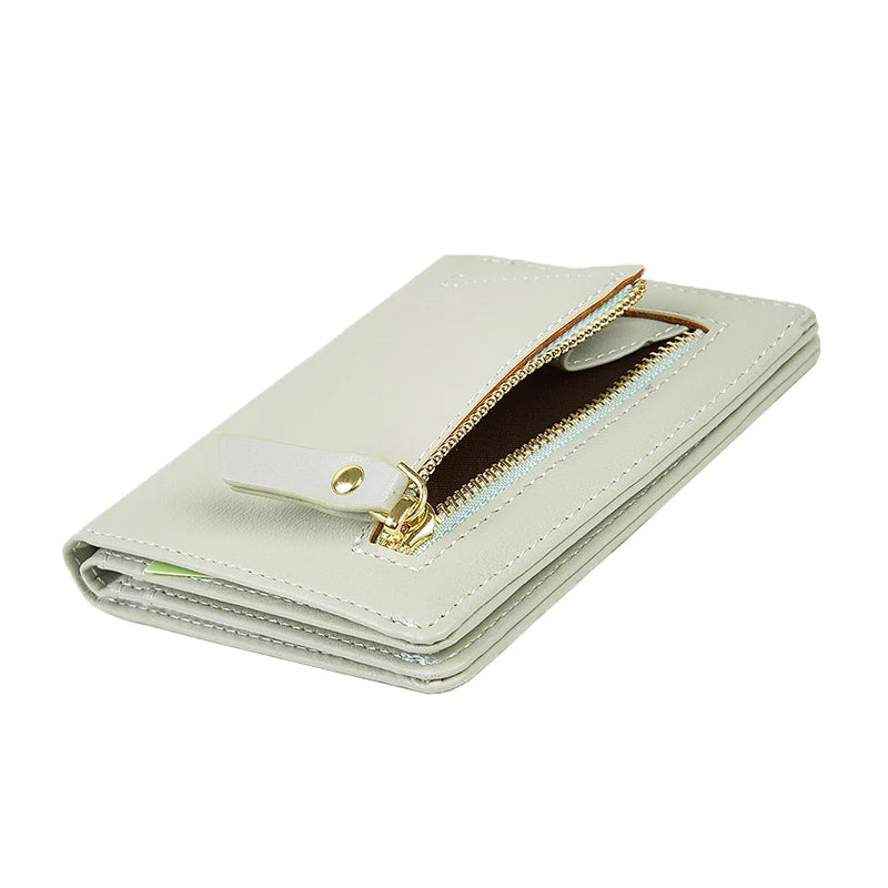 Light gray wallet with a gold zipper on a white background