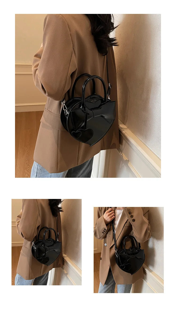 Person wearing a beige coat holding a black carauana-lovely-shoulder-bag-heart indoors.